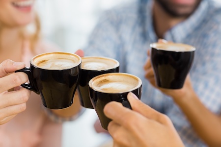Group of employees enjoying cups of hot coffee